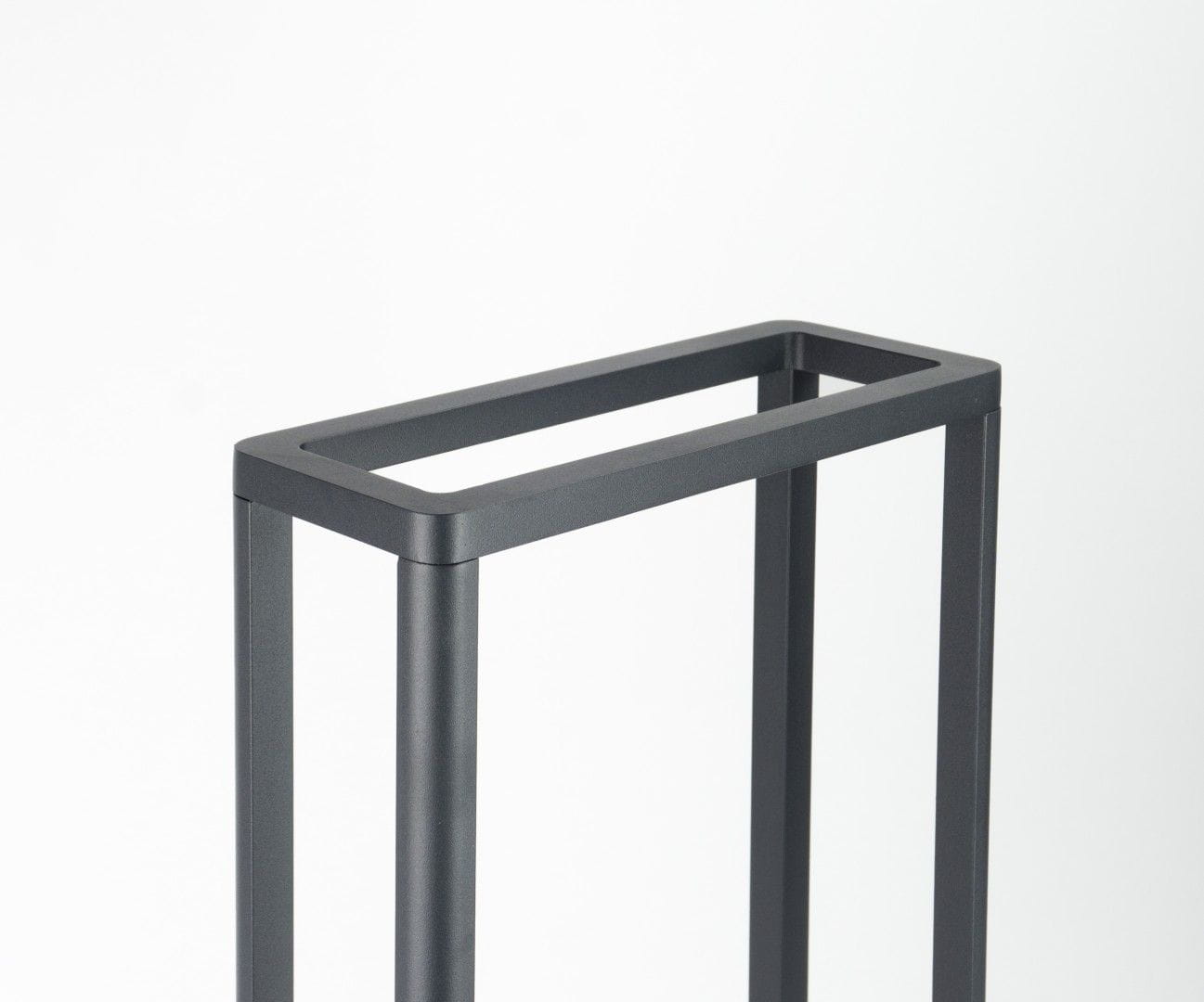 Lampa stojąca ogrodowa Arma H50 w ciemnym popiele, z prostokątnym ujęciem na górze, metalowa konstrukcja z czterema pionowymi nogami, minimalistyczny design, przeznaczona do montażu źródła światła LED 9W.