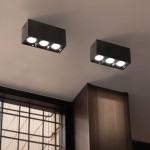 Lampa sufitowa LED o mocy 9W i temperaturze barwowej 4000K, czarna, zamontowana na suficie. Posiada dwa prostokątne korpusy z trzema okrągłymi źródłami światła w każdym. Tło stanowi gładka powierzchnia sufitu.