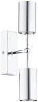 Kinkiet Frigga 2xGU10 w chromowanej obudowie, z dwiema cylindrycznymi osłonami lamp, zamontowany na prostokątnej podstawie. Produkt ma nowoczesny design, idealny do oświetlenia wnętrz. Montaż ścienny, widoczny detal mocowania.