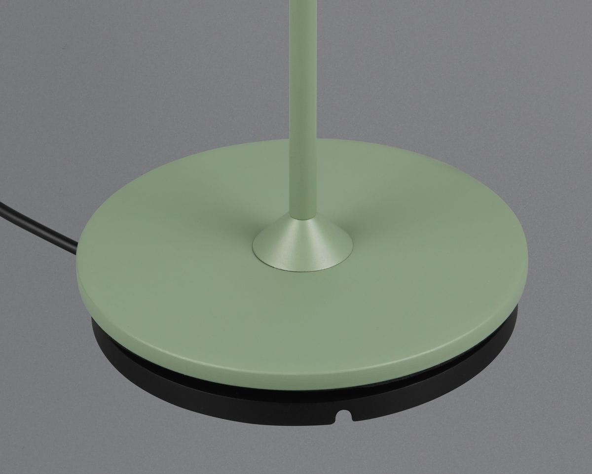 Lampa stołowa zewnętrzna Suarez w kolorze zielonym z okrągłą podstawą i metalowym stelażem, z widocznym kablem. Ujęcie z góry, ukazujące detal podstawy i jej matową fakturę. Wysokość lampy nie jest określona.