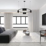 Czarna lampa wisząca Genesis z 10 gniazdami GU10, zawieszona na dwóch cienkich linkach. Lampa ma okrągły kształt i minimalistyczny design, umieszczona w nowoczesnym wnętrzu z jasnymi oknami i szarym narożnikiem.