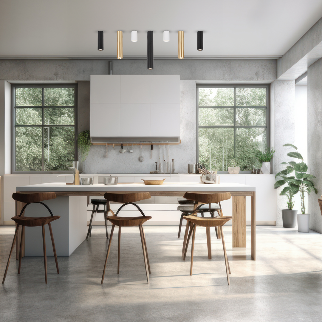 Czarna lampa sufitowa Genesis H20 z jednym gniazdem GU10, zawieszona w nowoczesnej kuchni. Lampa ma cylindryczny kształt i jest umiejscowiona na tle jasnych ścian oraz drewnianych elementów mebli. W pomieszczeniu widoczne są okna oraz rośliny.