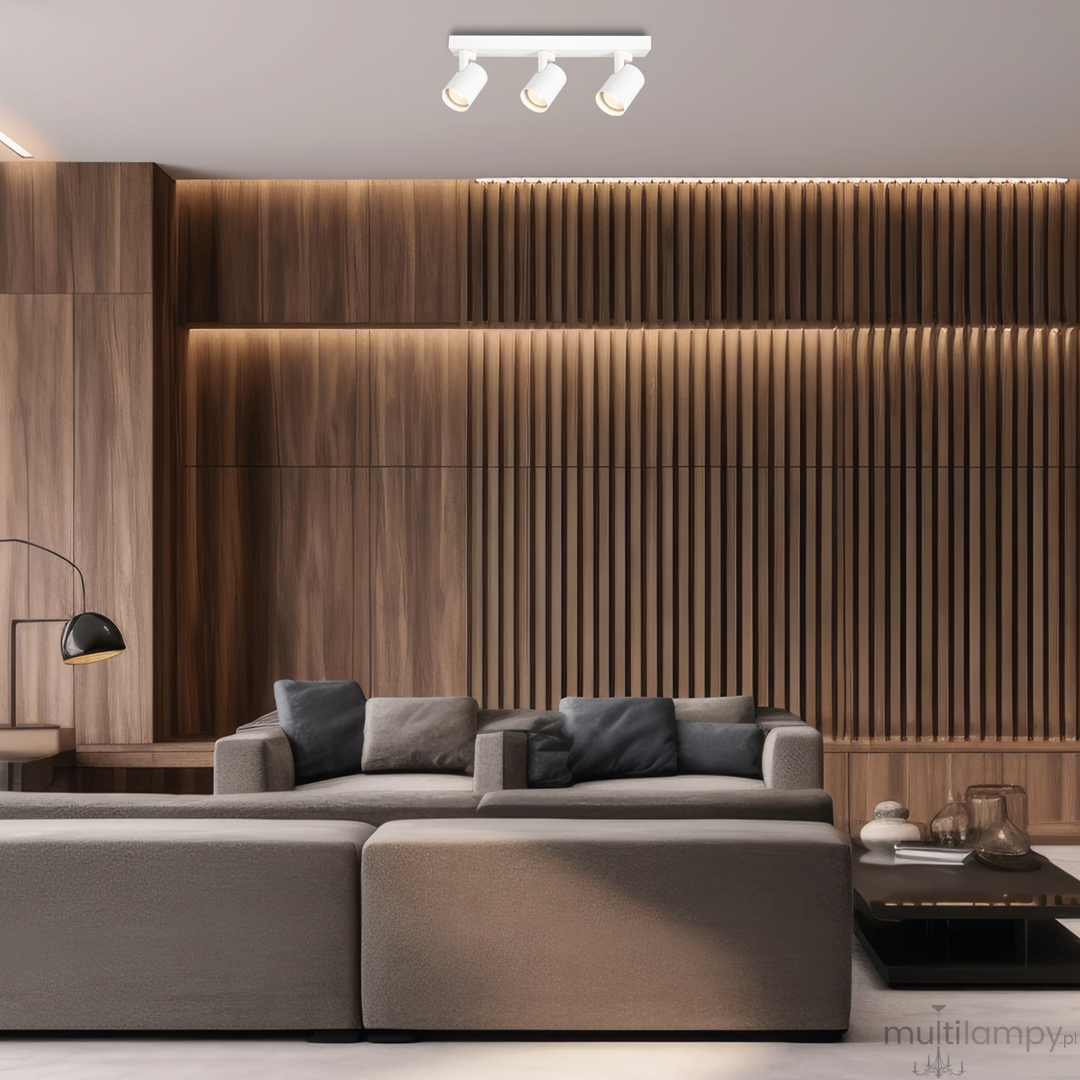 Lampa sufitowa Volf z trzema reflektorami GU10 w białym kolorze, zamontowana na jasnym suficie. Reflektory są skierowane w różne strony, a produkt jest umieszczony w nowoczesnym wnętrzu z drewnianą ścianą i sofą.