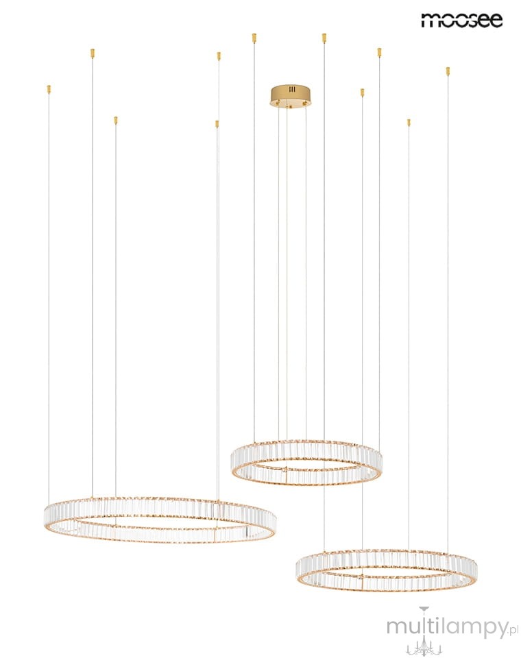 Lampa wisząca Liberty 3B z trzema okrągłymi kloszami, złota, z przezroczystymi szklanymi elementami. Ujęcie frontalne, zawieszona na cienkich linkach. Wysoka jakość wykonania, nowoczesny design, doskonała do wnętrz.