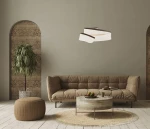 Lampa wisząca Rustin 1xLED/45W w kolorze kawowym, z nowoczesnym, falistym kształtem i drewnianymi akcentami, zawieszona nad okrągłym stołem w stylowym wnętrzu z brązową sofą i rośliną w tle.