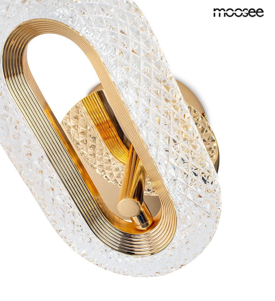 Kinkiet Jewel 1xLED/7W w kolorze złotym, z przezroczystym, diamentowym wzorem. Owalna forma z metalowymi detalami, zamontowany na okrągłej podstawie. Stylowy element oświetleniowy, idealny do nowoczesnych wnętrz.