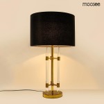 Lampa stołowa Moxy z podstawą w kolorze złotym i czarnym abażurem. Szklane elementy w dolnej części, prosty kształt. Ujęcie frontalne, lampa stoi na płaskiej powierzchni.