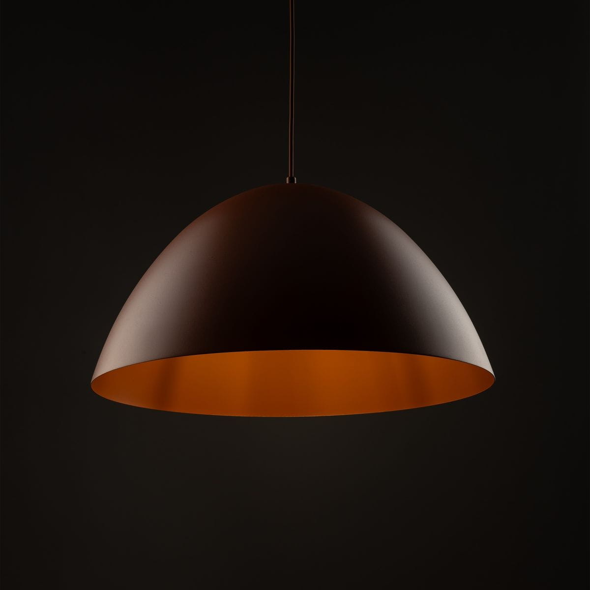 Lampa wisząca Faro D50 w kolorze ceglastym, z metalowym kloszem o kształcie półkuli, zawieszona na cienkim przewodzie. Wnętrze klosza w odcieniu pomarańczowym, co podkreśla ciepłe światło. Idealna do nowoczesnych aranżacji.