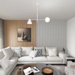 Lampa wisząca Hermes w kolorze białym, z jednym kloszem E27 i jednym E14. Ujęcie frontalne, zawieszona na cienkim kablu w nowoczesnym wnętrzu, nad jasną sofą i szklanym stolikiem. W tle widoczna drewniana ściana z obrazem oraz tekstylnymi dekoracjami.