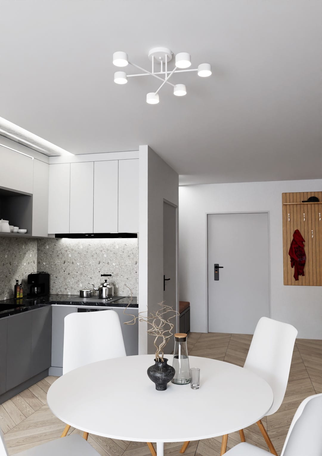 Biała lampa sufitowa Halo z sześcioma źródłami światła GX53, zamontowana na suficie w kuchni. Ma minimalistyczny design, z ramieniem rozłożonym w formie gwiazdy, pasujący do jasnych wnętrz. Tło to przestrzeń z szarymi meblami i stołem.