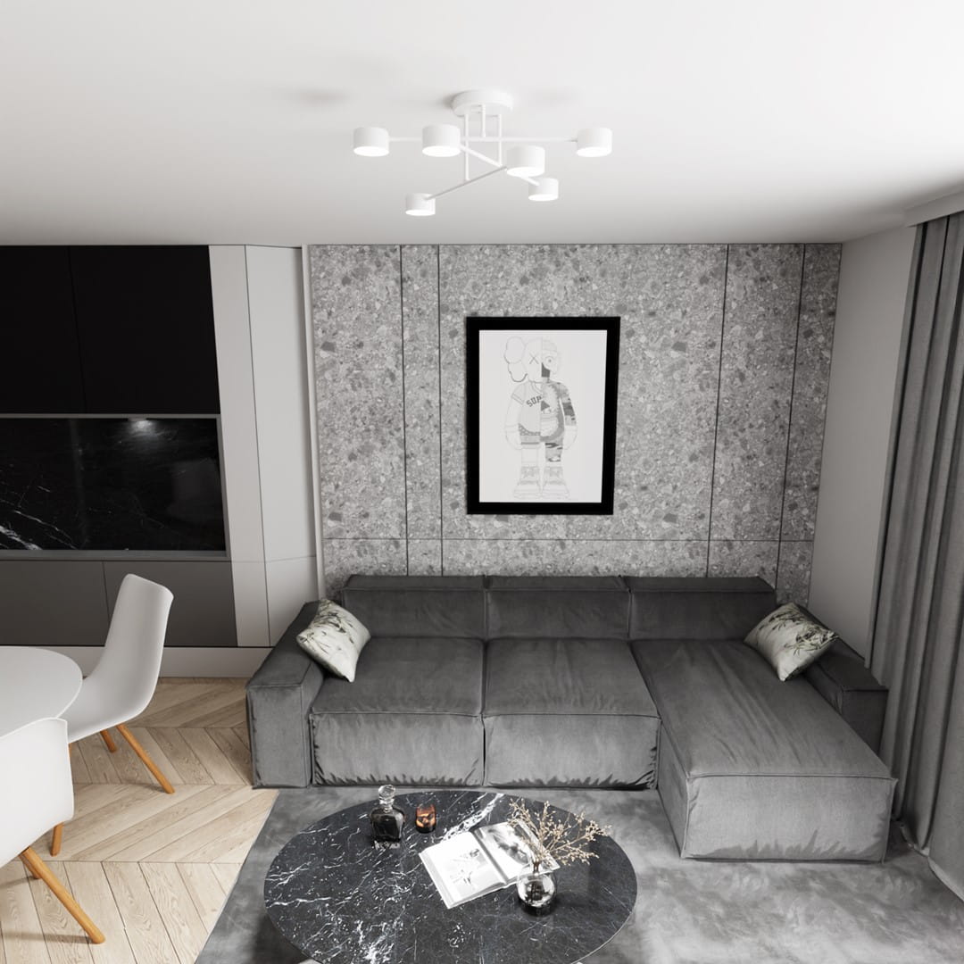 Biała lampa sufitowa Halo, 6xGX53, z ośmioma ramionami, zainstalowana na białym suficie. W tle widoczny szary narożnik z poduszkami i okrągły stół kawowy z czarnym marmurowym blatem, na którym leży książka i dekoracje.