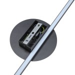Kinkiet Java 1xLED/22W w kolorze czarnym, zamontowany na okrągłej podstawie. Widoczny metalowy element mocujący oraz przewody. Lampa ma prostą, minimalistyczną formę z długim, wąskim źródłem światła LED.