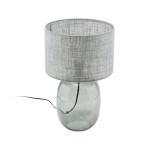 Melody lampa stołowa z grafitowym, tekstylnym kloszem oraz przezroczystą, szklaną podstawą. Lampa ma okrągły kształt, a kabel zasilający jest widoczny z boku. Idealna do nowoczesnych aranżacji wnętrz.