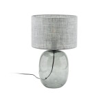 Lampa stołowa Melody z grafitowym, szklanym korpusem w kształcie owalnym oraz szarym, tekstylnym kloszem. Ujęcie frontalne, widoczny przewód zasilający. Idealna do nowoczesnych wnętrz.