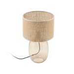 Lampa stołowa Melody z bursztynowym, szklanym stelażem i brązowym, lnianym kloszem. Produkt stoi na płaskiej powierzchni, z widocznym przewodem zasilającym w kolorze czarnym. Klosz ma okrągły kształt i delikatną teksturę.