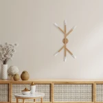 Lampa sufitowa Noble 6xG9 w jasnym drewnie, z sześcioma źródłami światła umieszczonymi na drewnianych ramionach, zamontowana na okrągłej podstawie. Produkt umieszczony na jasnej ścianie, w otoczeniu dekoracji i mebli drewnianych.