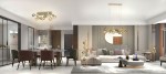 Złota lampa stołowa Metz 2xG9 umieszczona w nowoczesnym wnętrzu. Lampa ma elegancki, okrągły kształt i jest włączona, emitując ciepłe światło. W tle widoczne meble i dekoracje w stonowanych kolorach, tworzące harmonijną aranżację.