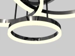 Czarna lampa sufitowa Perpignon z trzema okrągłymi oprawami LED, z chromowanym wykończeniem. Widoczne są dwa pierścienie z białym światłem i połyskująca, gładka powierzchnia. Lampa zawieszona pod kątem, na szarym tle.