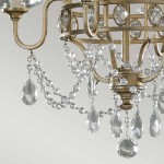 Lampa wisząca Gianna w postarzanym srebrze, wyposażona w łańcuchy z przezroczystych kryształów i długie, zwisające krople. Widok z bliska na detal zdobień oraz strukturę metalu. Nowoczesny design, idealna do eleganckich wnętrz.