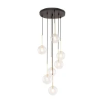 Lampa wisząca Nilos z siedmioma kulistymi kloszami G9, czarna podstawa z metalowymi linkami. Klosze w odcieniu transparentnym, o różnej wysokości, zawieszone z sufitu. Prosty, nowoczesny design.