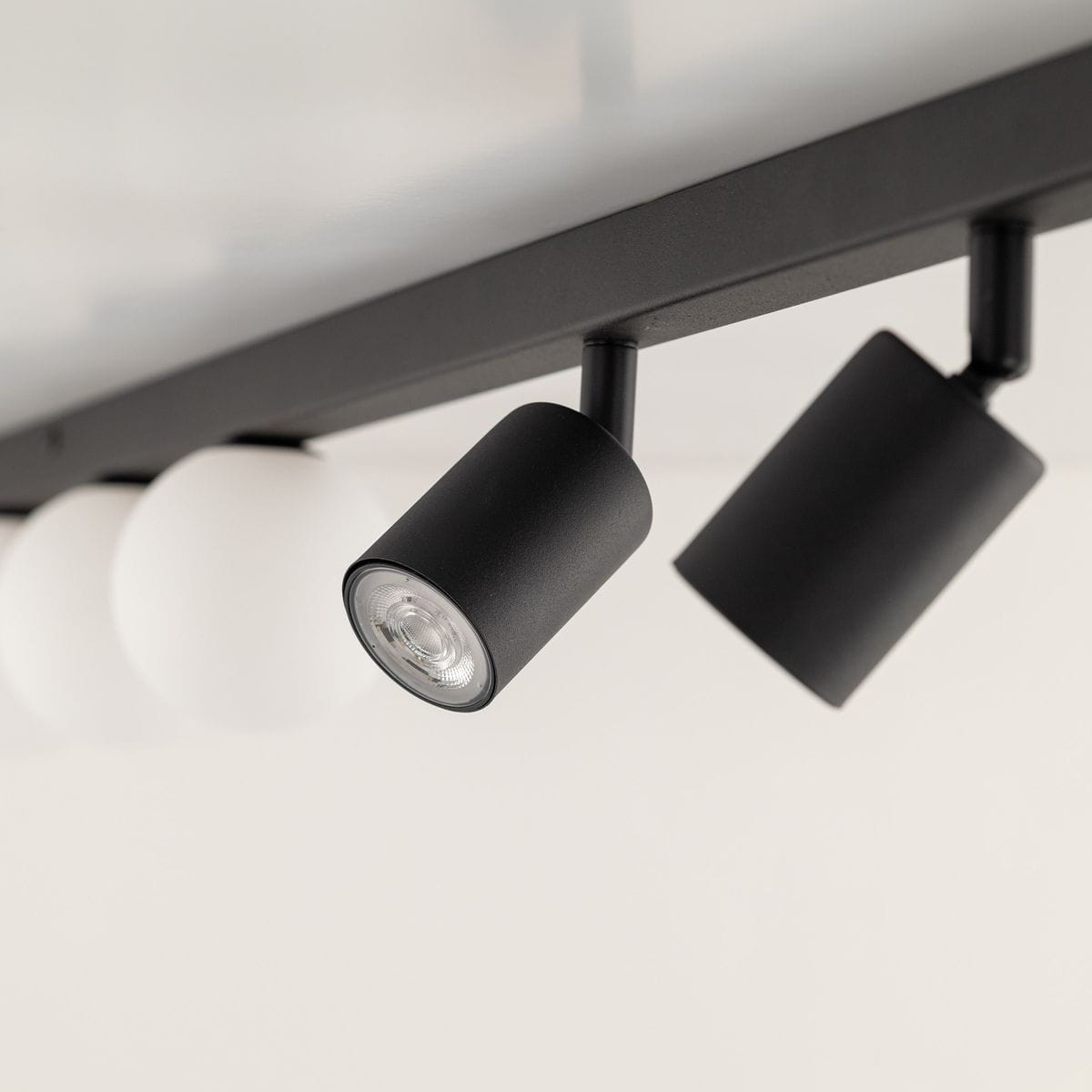 Lampa sufitowa Vox w kolorze czarnym z trzema punktowymi źródłami światła GU10 oraz trzema G9. Ujęcie z boku, ukazujące detale opraw z matowym wykończeniem. Idealna do nowoczesnych wnętrz.