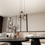 Lampa wisząca Vander 3xE27 w czarnej metalowej obudowie, z trzema kloszami w formie siatki, zawieszona nad stolikami kawowymi w nowoczesnym wnętrzu. Tło jasne, z elementami dekoracyjnymi w aranżacji.