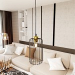 Lampa wisząca Vander 1 l z kloszem w formie czarnej metalowej siatki z złotym detalem, zawieszona na cienkim przewodzie. Widoczna w nowoczesnym wnętrzu, na tle jasnej kanapy i regału. Idealna do oświetlenia przestrzeni.