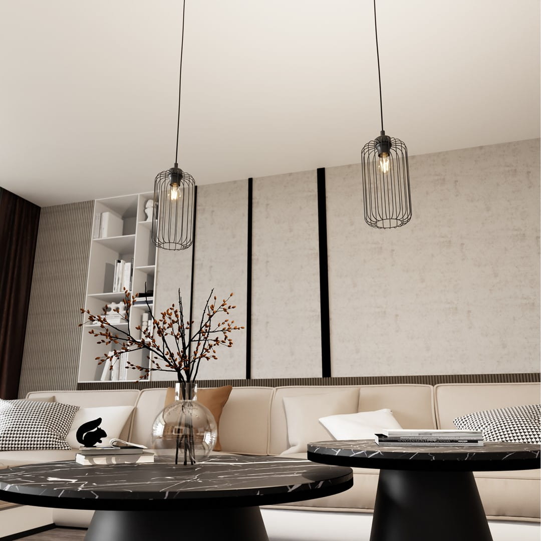 Lampa wisząca Vander 1BL w czarnej metalowej obudowie z siatki, zawieszona na długim przewodzie. Widoczna żarówka E27. Produkt w nowoczesnym wnętrzu, na tle jasnej ściany i mebli w stonowanych kolorach.
