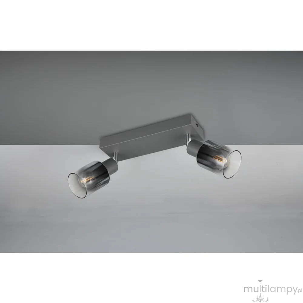Lampa sufitowa Cadiz w kolorze antracytowym z dwoma reflektorami E14. Metalowa konstrukcja z matowym wykończeniem, szklane klosze w ciemnym odcieniu, zamontowana na suficie. Reflektory mogą być regulowane w kierunku oświetlenia.
