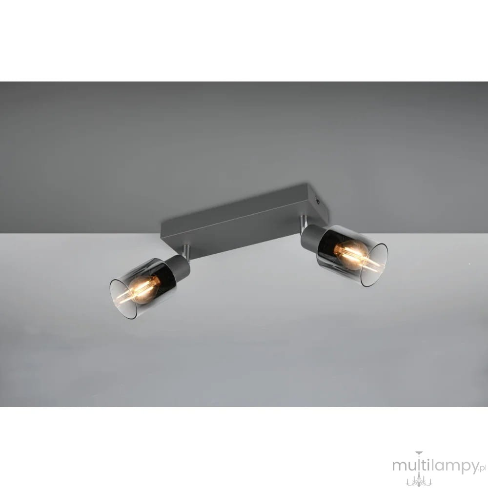 Lampa sufitowa Cadiz w kolorze antracytowym z dwoma punktami świetlnymi, zamocowana na prostokątnej podstawie. Każdy klosz wykonany z przezroczystego materiału, eksponującego żarówki E14. Ujęcie z góry, na jednolitym tle.