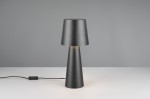 Czarna lampa stołowa Nubian z kloszem w kształcie odwróconego stożka, wykonana z matowego materiału. Stoi na białym blacie, z widocznym kablem i włącznikiem. Źródło światła E27. Tło w odcieniach szarości.