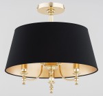Lampa sufitowa Rosetta 3xE14 w kolorze złotym i czarnym. Okrągły abażur z czarnej tkaniny, złote detale, trzy ramiona z eleganckimi uchwytami. Zawieszona na prostym, metalowym mocowaniu. Wymiary i szczegóły konstrukcji nie są widoczne.