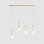 Lampa wisząca Bosso z czterema kulistymi kloszami w białym kolorze, zawieszona na mosiężnym stelażu. Klosze umieszczone na cienkich, białych przewodach, tworzą minimalistyczny design. Produkt zawiera gniazda E14.
