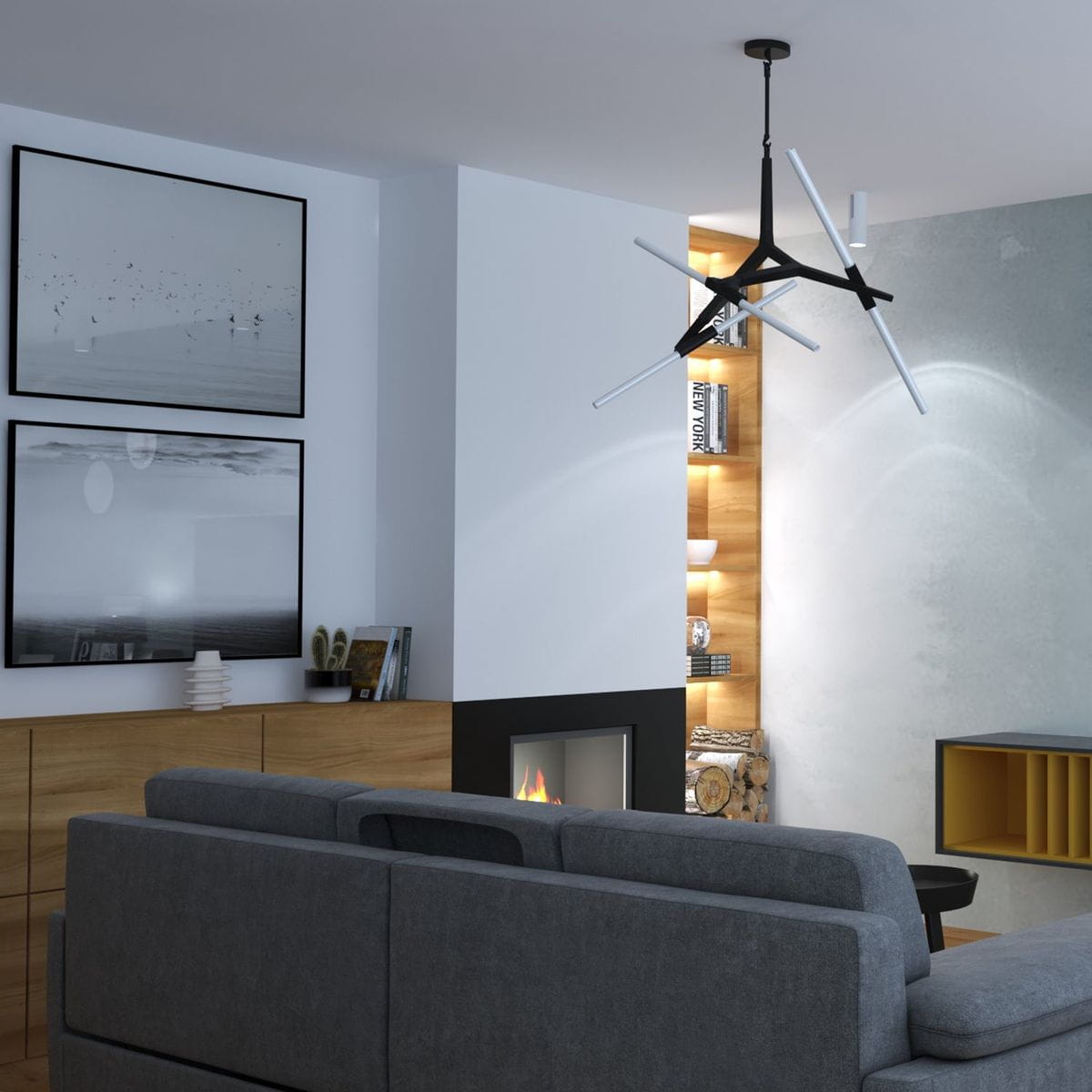 Lampa wisząca Sticks w kolorze czarnym, z sześcioma punktami świetlnymi G9, zawieszona w nowoczesnym wnętrzu. Posiada asymetryczny kształt z białymi rurkami świetlnymi. Otoczenie: szara ściana, drewniana meblościanka i komfortowa kanapa.