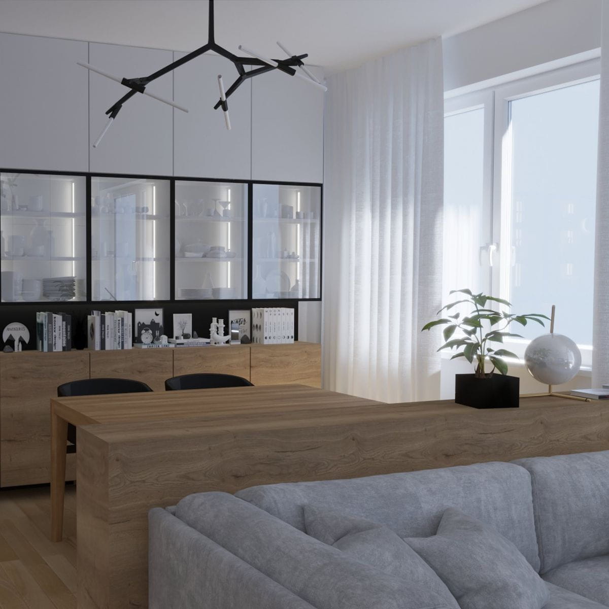 Lampa wisząca Sticks w kolorze czarnym, z dziesięcioma punktami świetlnymi G9, zawieszona w nowoczesnym wnętrzu. Widoczna w aranżacji nad drewnianym stołem, z minimalistycznym tłem i rośliną w doniczce.