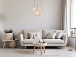 Lampa wisząca Bina 3xE27 w kolorze czarnym, zawieszona nad jasną sofą w minimalistycznym wnętrzu. Szklane klosze w kształcie kul z delikatnym wzorem, na tle gładkiej, jasnej ściany. Idealna do nowoczesnych aranżacji.