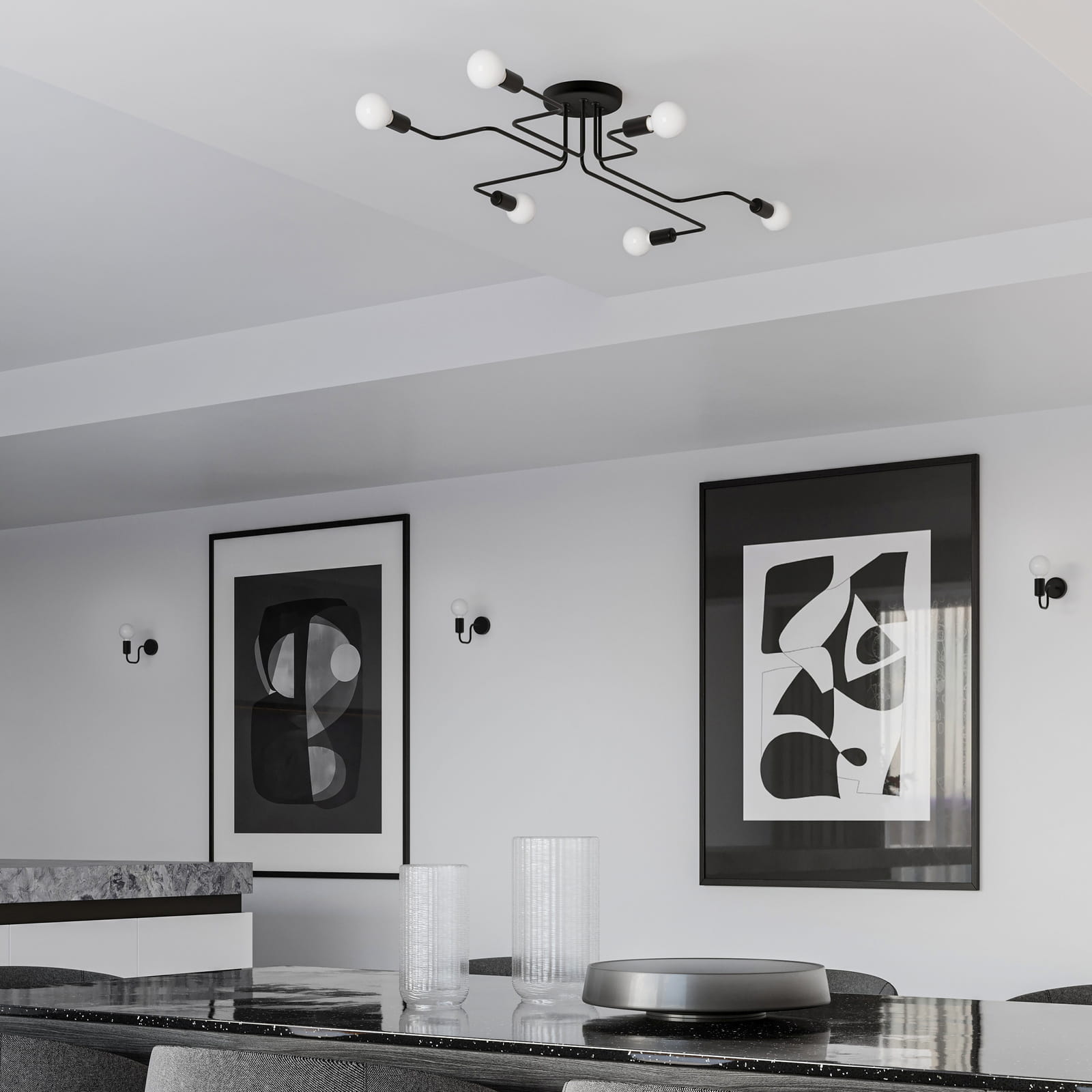 Czarna lampa sufitowa Vector z sześcioma źródłami światła E27, z metalową konstrukcją w minimalistycznym stylu. Ujęcie z góry, zamontowana na suficie, w nowoczesnym wnętrzu z grafikami na ścianach i eleganckim blatem.