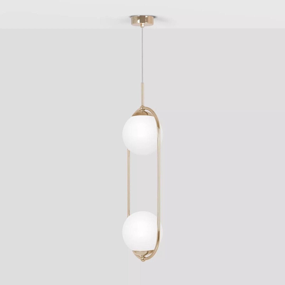 Lampa wisząca Ritus z dwoma okrągłymi białymi kloszami na złotym stelażu, zawieszona na cienkim przewodzie. Produkt ma nowoczesny design, idealny do wnętrz. Klosze umieszczone są na różnych wysokościach, co podkreśla jego elegancki charakter.