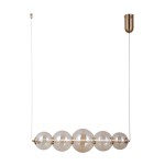Lampa wisząca Butero 1xLED/18W w złotym kolorze, z pięcioma przezroczystymi kulami o różnej wielkości, zawieszona na cienkim, białym przewodzie. U góry metalowy uchwyt montażowy w złotym odcieniu.