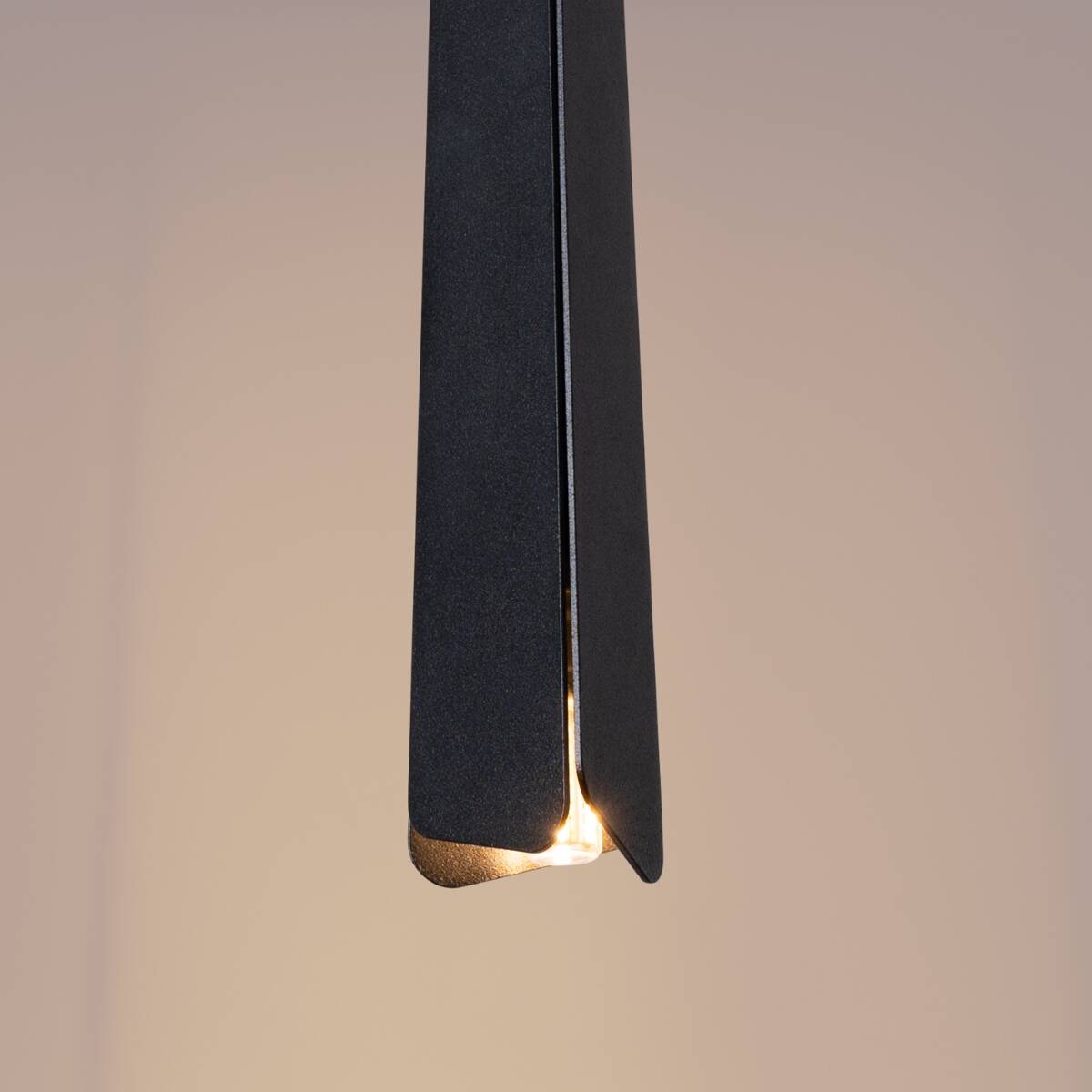 Lampa wisząca Prysm 3xG9 w kolorze czarnym, o prostokątnym kształcie, zawieszona w pionie. Wnętrze klosza odsłania źródło światła, a struktura ma matowe wykończenie. Tło w jasnym odcieniu, co podkreśla elegancki wygląd lampy.