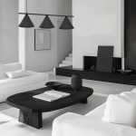 Czarna lampa wisząca Capital z trzema kloszami w kształcie stożków, zawieszona nad okrągłym, czarnym stołem. Lampa ma minimalistyczny design, a w tle znajduje się nowoczesny salon w odcieniach bieli i czerni.