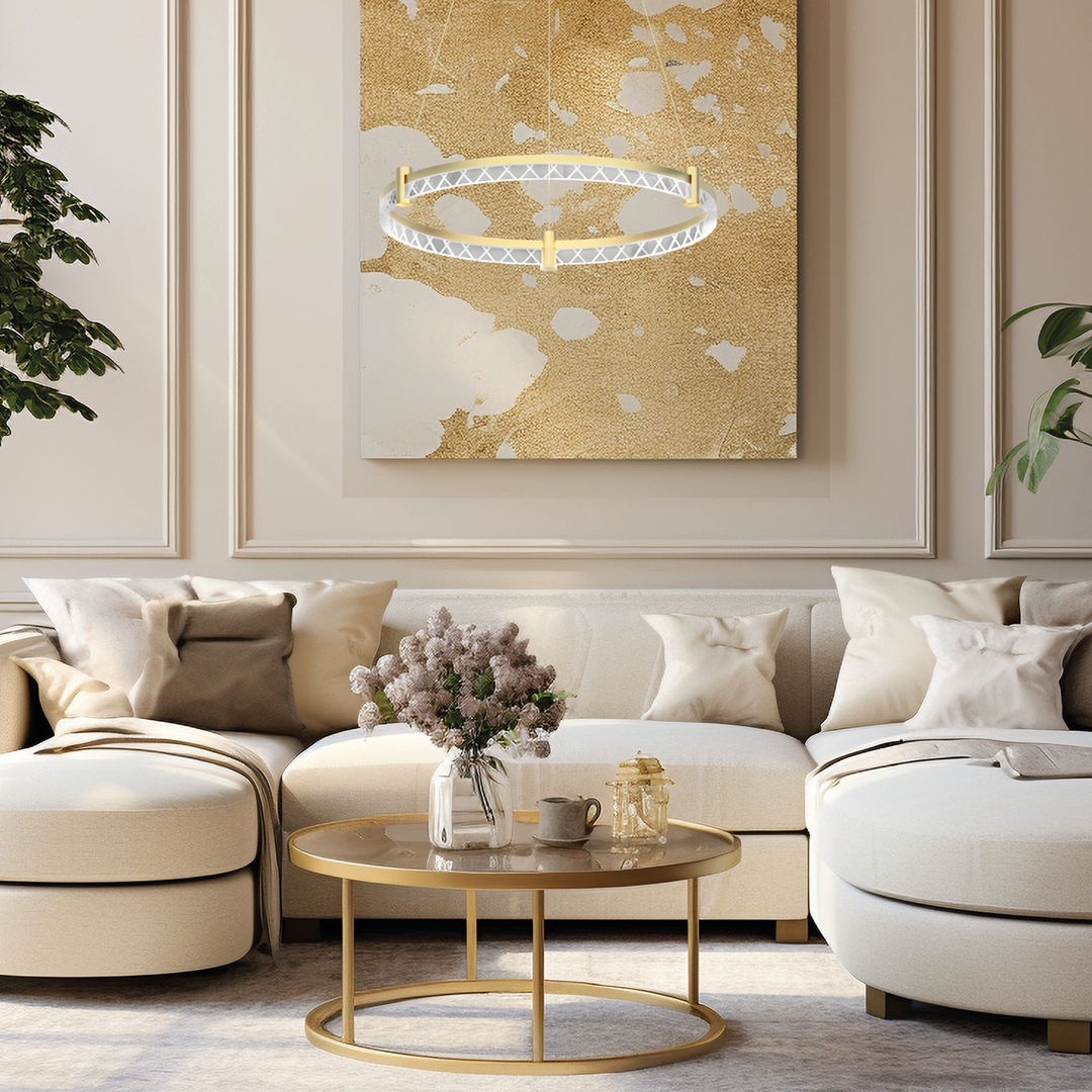 Złota lampa wisząca Elegance D60 z jednym źródłem LED o mocy 36W, w kształcie okręgu z delikatnym, geometrycznym wzorem, zawieszona w eleganckim wnętrzu z jasnymi sofami i ozdobnym obrazem w tle.