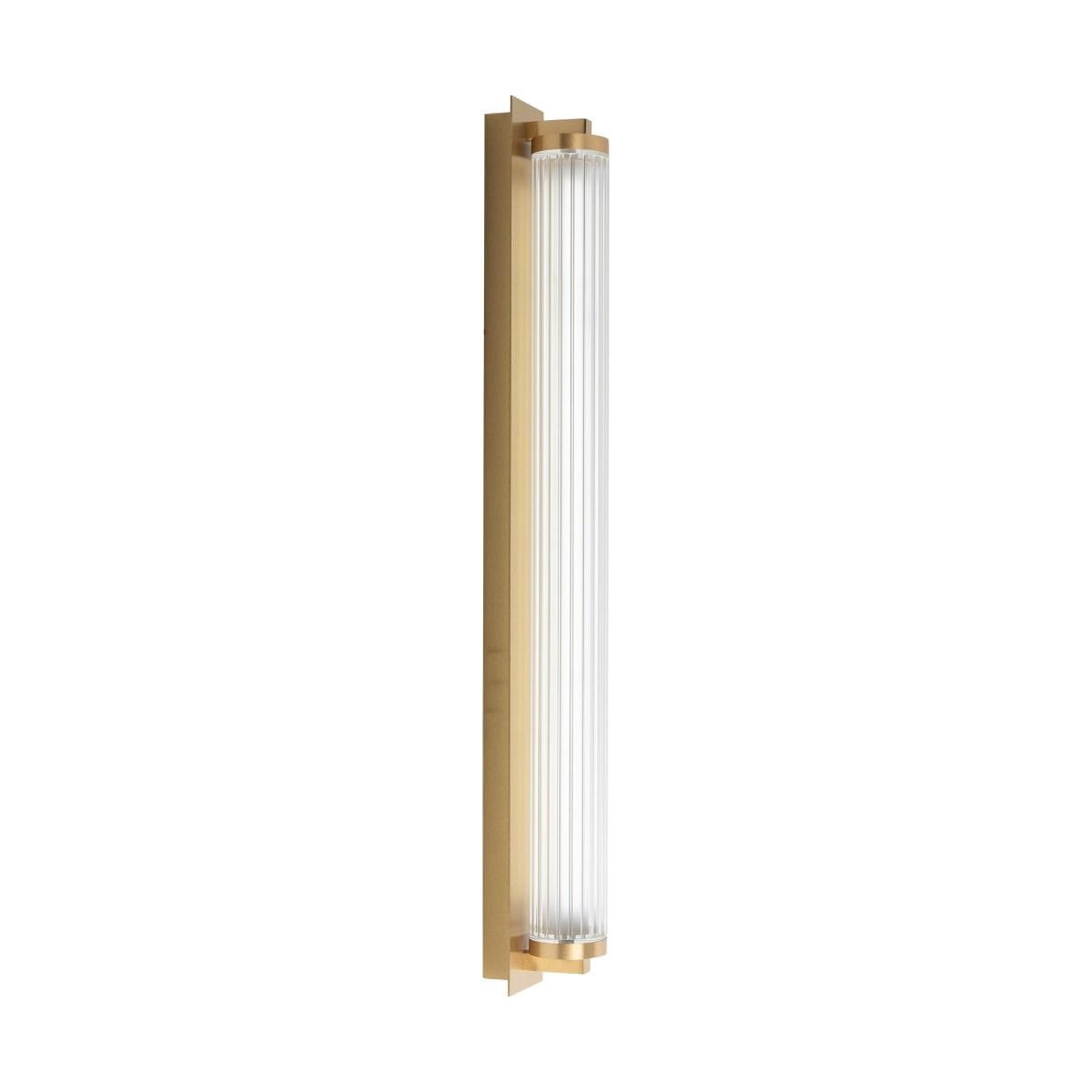 Kinkiet Como w kolorze mosiądzu z pilotem, z cylindrycznym, przezroczystym kloszem LED o mocy 26W. Produkt montowany na ścianie, widoczny z boku, z prostą, elegancką konstrukcją.