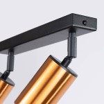 Lampa sufitowa Winx (spot) z dwoma reflektorami GU10 w kolorze czarnym i miedzi. Ujęcie z boku, pokazujące detal mocowania i cylindryczny kształt lamp, posiadające czarne końcówki. Montaż na sufit, nowoczesny design.