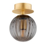Kinkiet Paloma 1xE14 w mosiężnym wykończeniu z dymnym, szklanym kloszem. Okrągły kształt z widoczną żarówką, zamocowany do sufitowej podstawy. Klosz z delikatnym wzorem, w kolorze dymnym, tworzy elegancki akcent w aranżacji wnętrza.