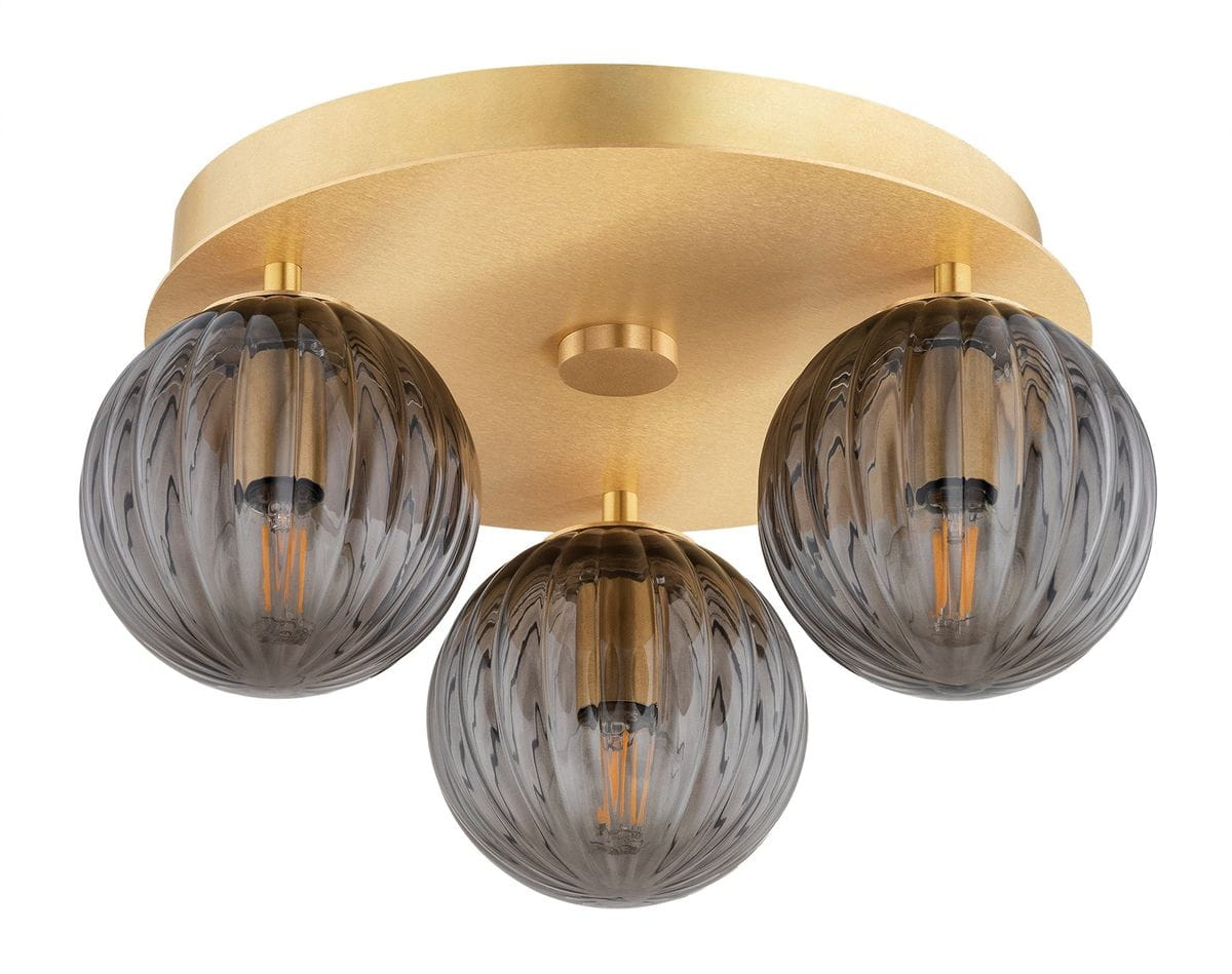 Lampa sufitowa Paloma w mosiężnym wykończeniu z trzema dymnymi kulami. Kule mają fakturę wzdłużnych rowków, a każda z nich mieści żarówkę E14. Lampa zamontowana na okrągłej, złotej podstawie.