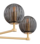 Żyrandol Paloma z pięcioma oprawami E14, wykonany z mosiądzu w kolorze złotym. Posiada dymne, okrągłe klosze z teksturowanego szkła, zamontowane na prostokątnych ramionach. Klosze w zbliżeniu, ukazujące detale i połyskujący materiał.