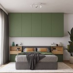 Lampa sufitowa Elba w białym kolorze, wyposażona w dwa reflektory E27, zamontowana na suficie w sypialni. Reflektory skierowane w różnych kierunkach, o prostym, nowoczesnym designie, idealnie komponują się z zieloną zabudową meblową.