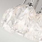 Lampa wisząca Rubin z siedmioma kloszami G9, wykonana z przezroczystego szkła z wzorem w formie fal. Uchwyt w kolorze satynowego niklu, z eleganckim wykończeniem. Widok z góry, pokazujący detale kloszy.