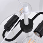 Lampa podłogowa Fogo w kolorze białym, z miejscem na dwie żarówki E27. Widoczny czarny uchwyt i elementy dekoracyjne, zbliżenie na gniazda żarówek i strukturalne detale. Prosty, nowoczesny design, idealna do wnętrz.